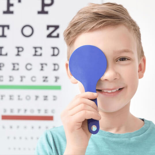 Young boy taking an annual eye exam at Medical Optometry America