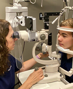 Boy getting eye exam for myopia detection at Medical Optometry America