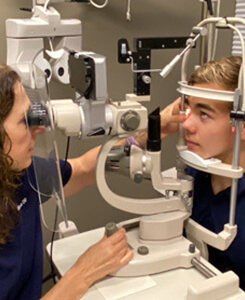 Boy getting an eye exam for myopia at Medical Optometry America